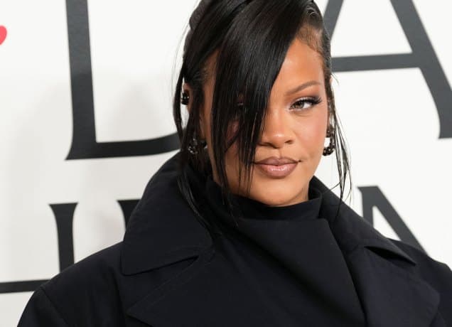 a photo of rihanna with a black coat