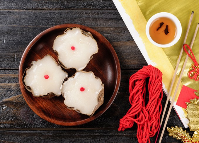 traditional chinese new year foods: three nián gāo new year cakes on a plate