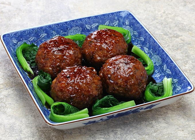 traditional chinese new year foods: four lion's head meatballs on a plate